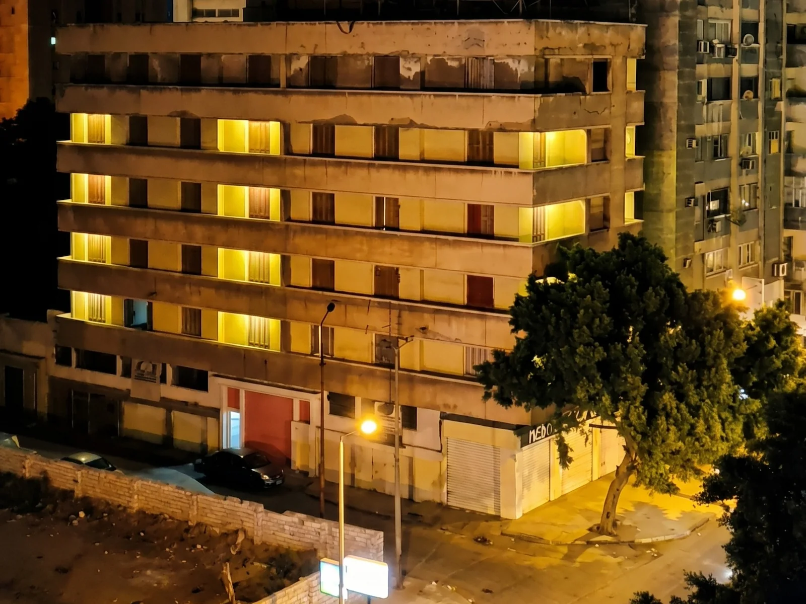 The old Heritage Legend building lit at night before redevelopment